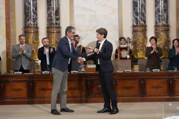 El nuevo alcalde de San Sebastián, Jon Insausti (d), toma posesión del cargo del hasta ahora alcalde Eneko Goia (i) durante un pleno extraordinario en el Ayuntamiento de San Sebastián, a 29 de octu