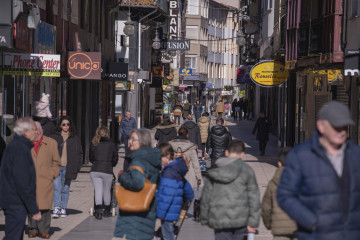 Archivo - Gente paseando junto a comercios de Torrelavega (Cantabria).
