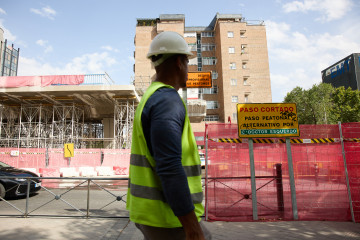 Archivo - Un albañil pasa por una obra, a 10 de agosto de 2022, en Madrid (España).