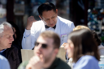 Archivo - Un camarero de nacionalidad extranjera atendiendo a unos clientes en una terraza de Madrid