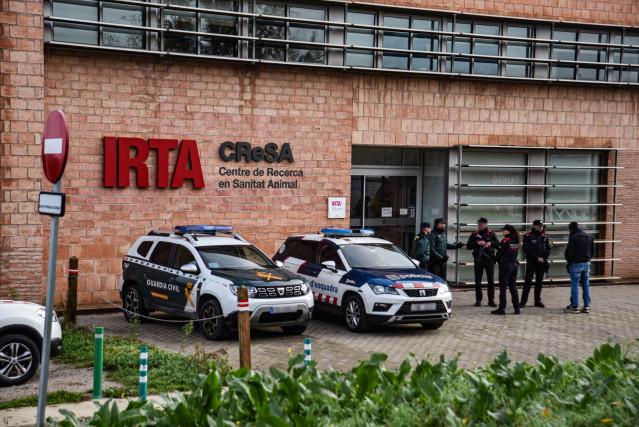 Agentes de la Guardia Civil y los Mossos d'Esquadra en el laboratorio del IRTA