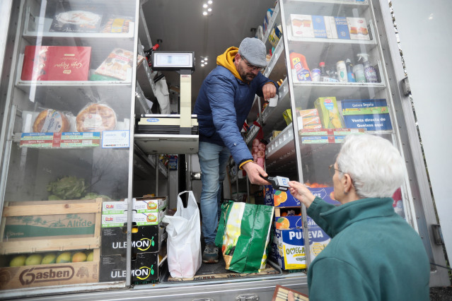 Archivo - Un hombre comprando productos en un comercio ambulante