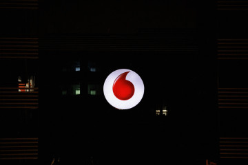 Archivo - Logo de la empresa de Vodafone encendido, en Madrid (España)