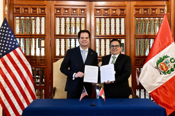 El embajador de Estados Unidos en Perú, Bernie Navarro, y el presidente ejecutivo de la Agencia de Promoción de la Inversión Privada (Proinversión) de Perú, Luis del Carpio, firman un memorándum