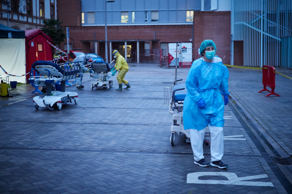 Varios voluntarios de DYA Navarra trasladan una de las camillas utilizadas en las ambulancias del Servicio de Urgencias del Hospital de Navarra para quitar a pacientes Infectados con coronavirus durant la tercera semana de Estado de Alarma